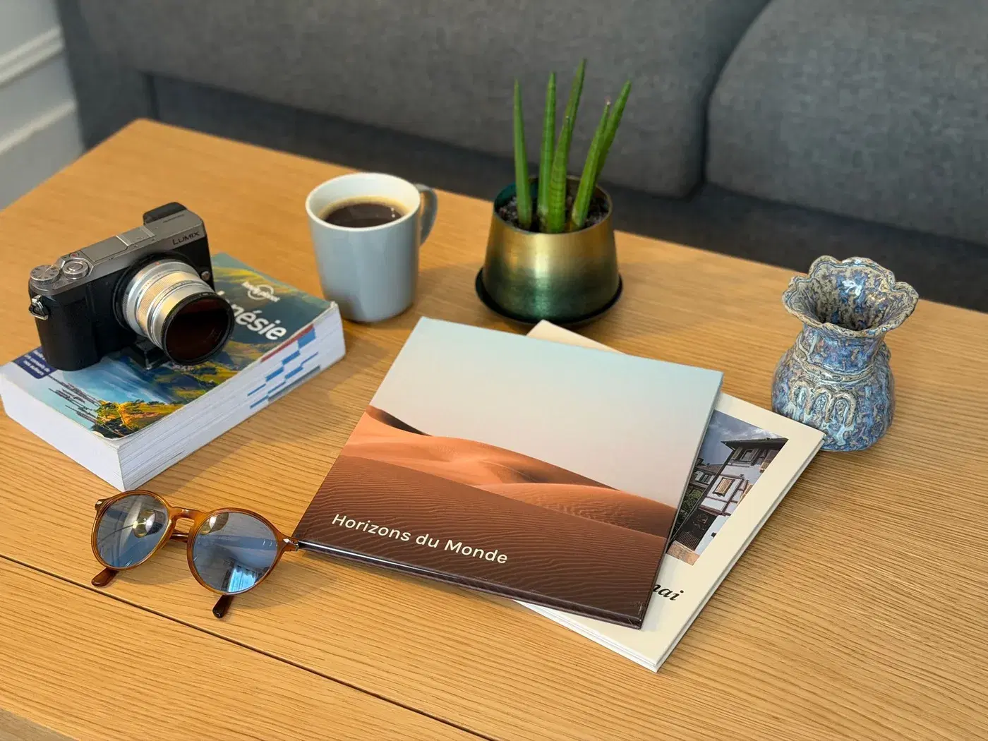 The closed album on a coffee table, its desert-dune cover facing up